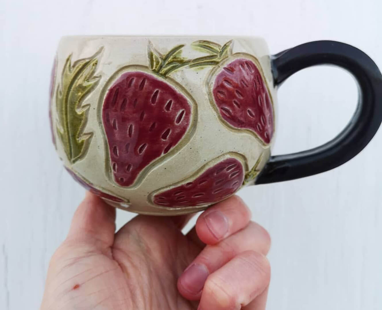 handmade mug with strawberries on it