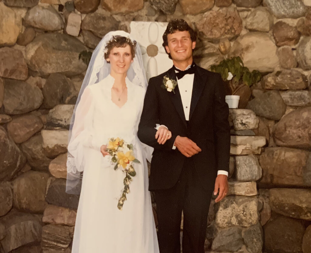 Man and woman post on their wedding day in 1977