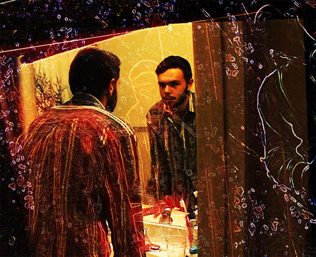 Man stands in bathroom looking at his reflection on ACID