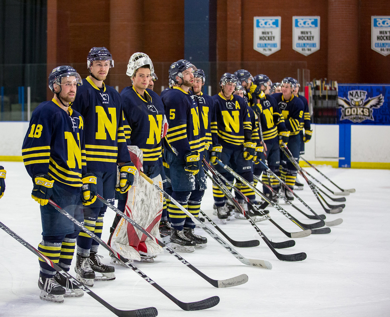 NAIT Men's hockey team line up in arena before a game