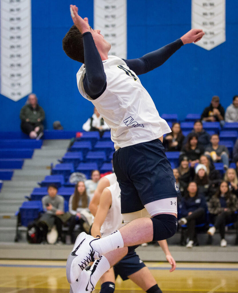 Man sets volleyball over net