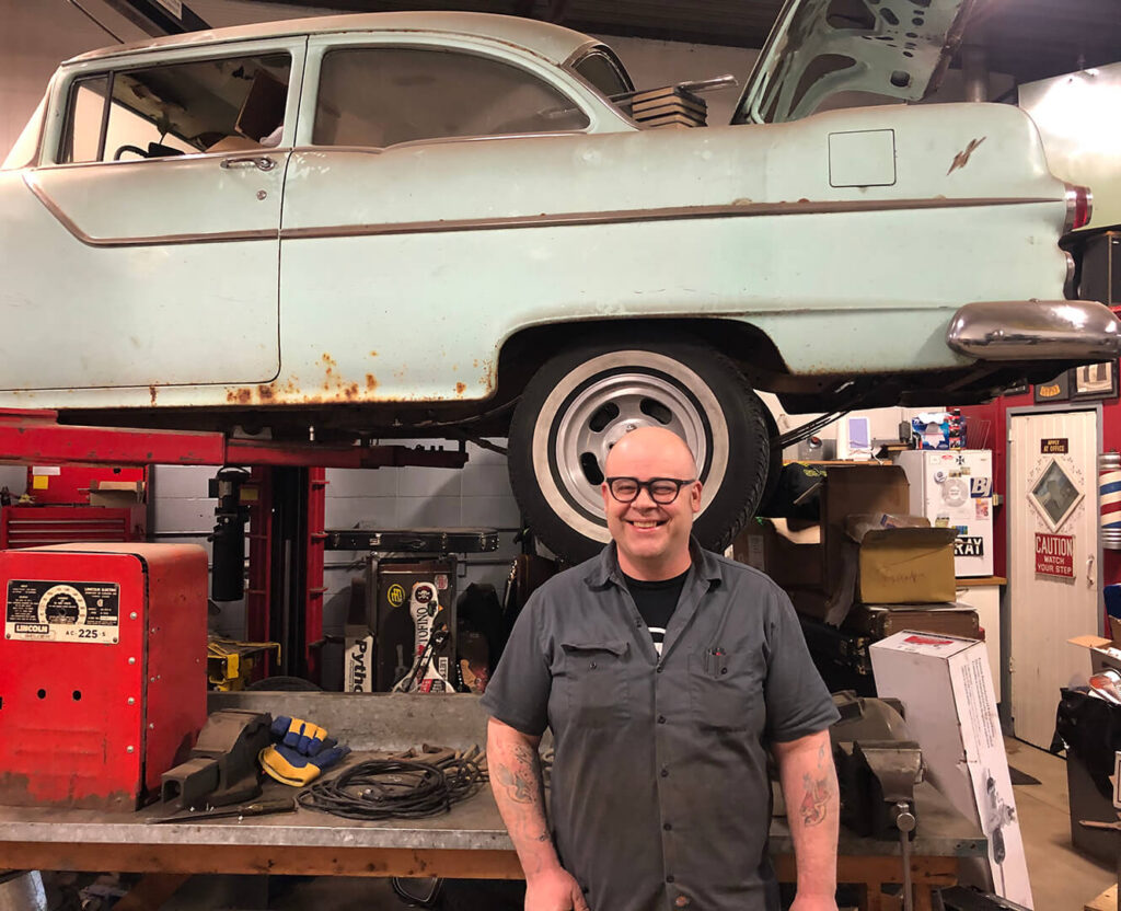 Ted Wright stands in front of his passion project in his shop, Wright Automotive