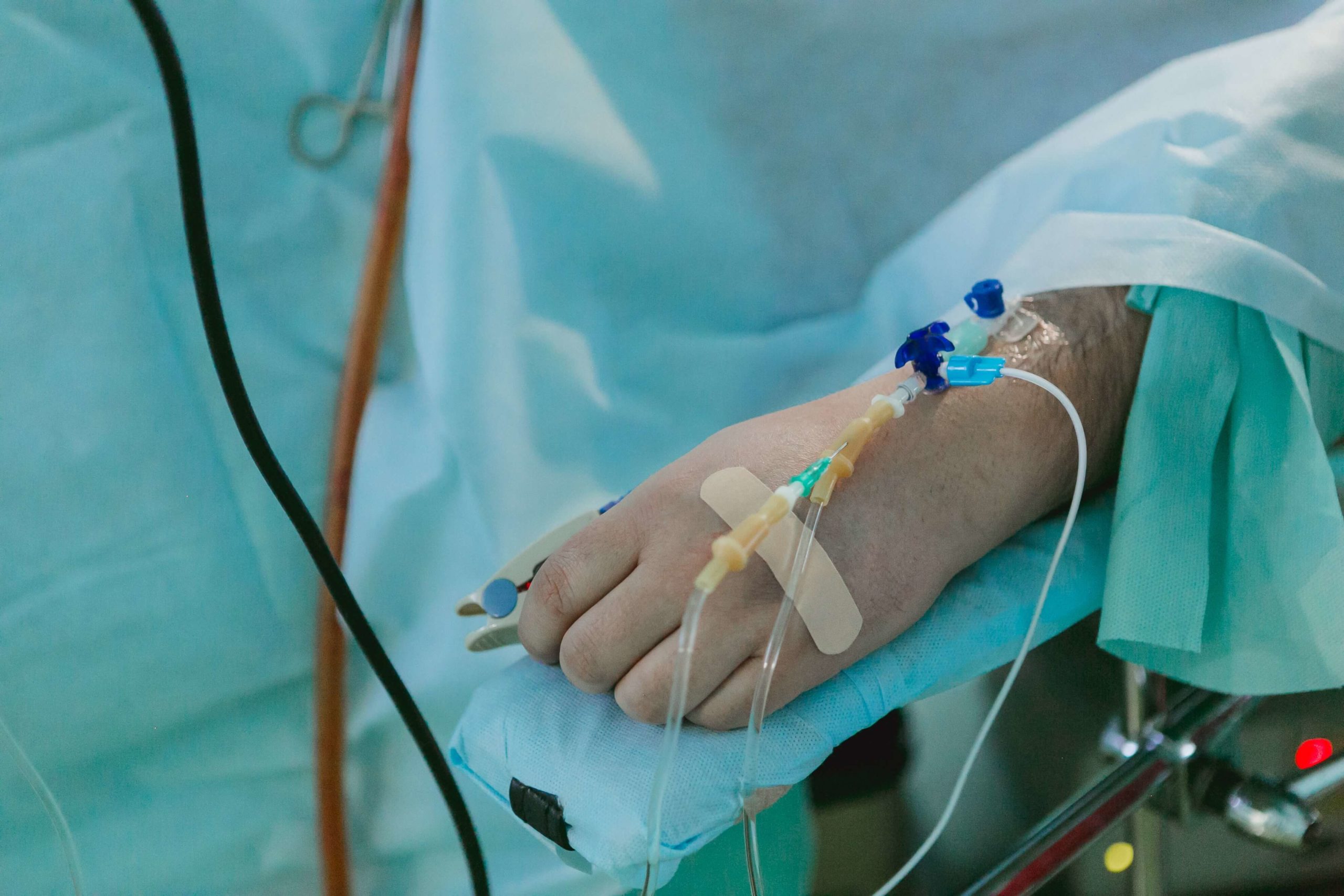 Man in hospital with IV trip on his hand