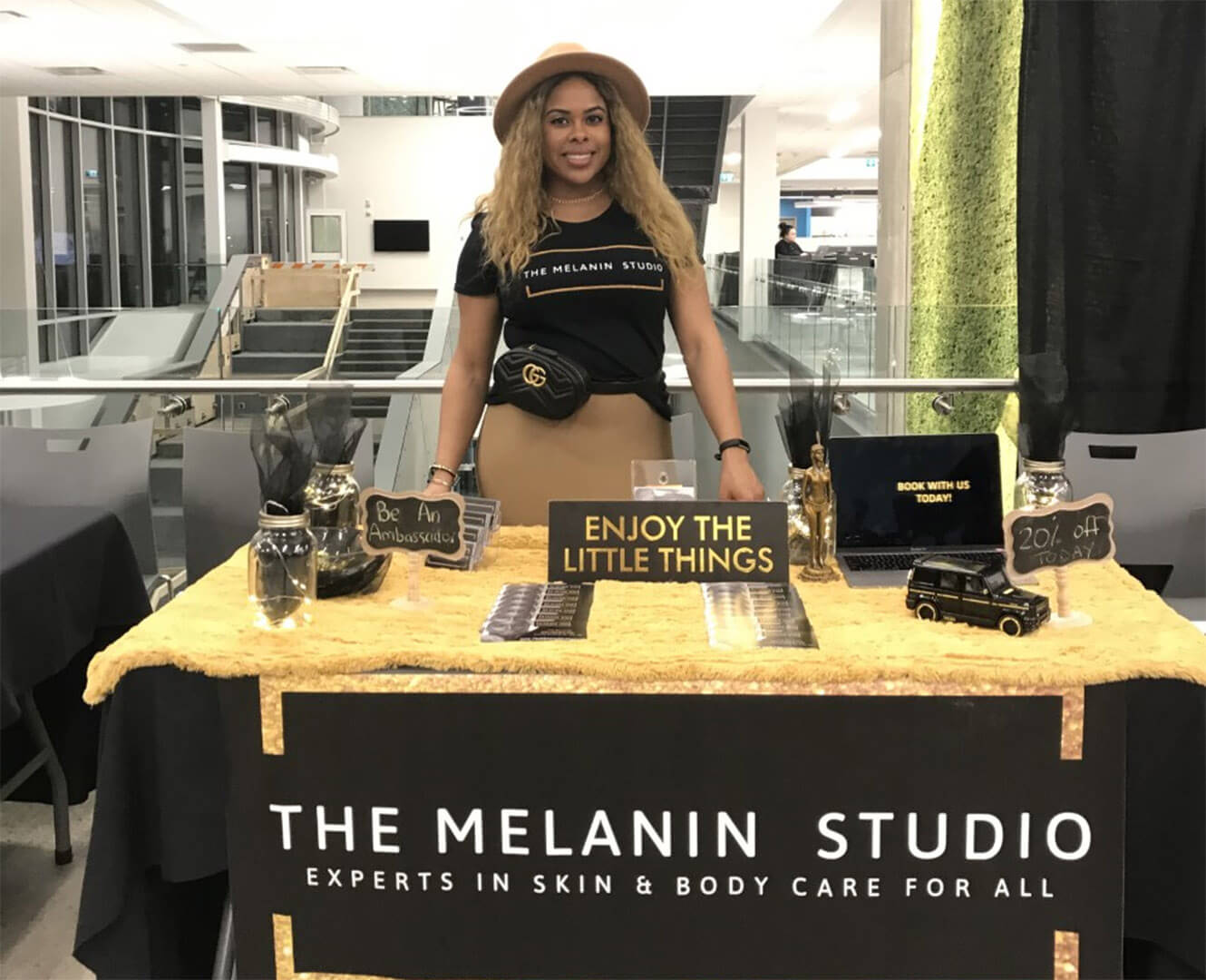 Woman stands at table selling skin care products