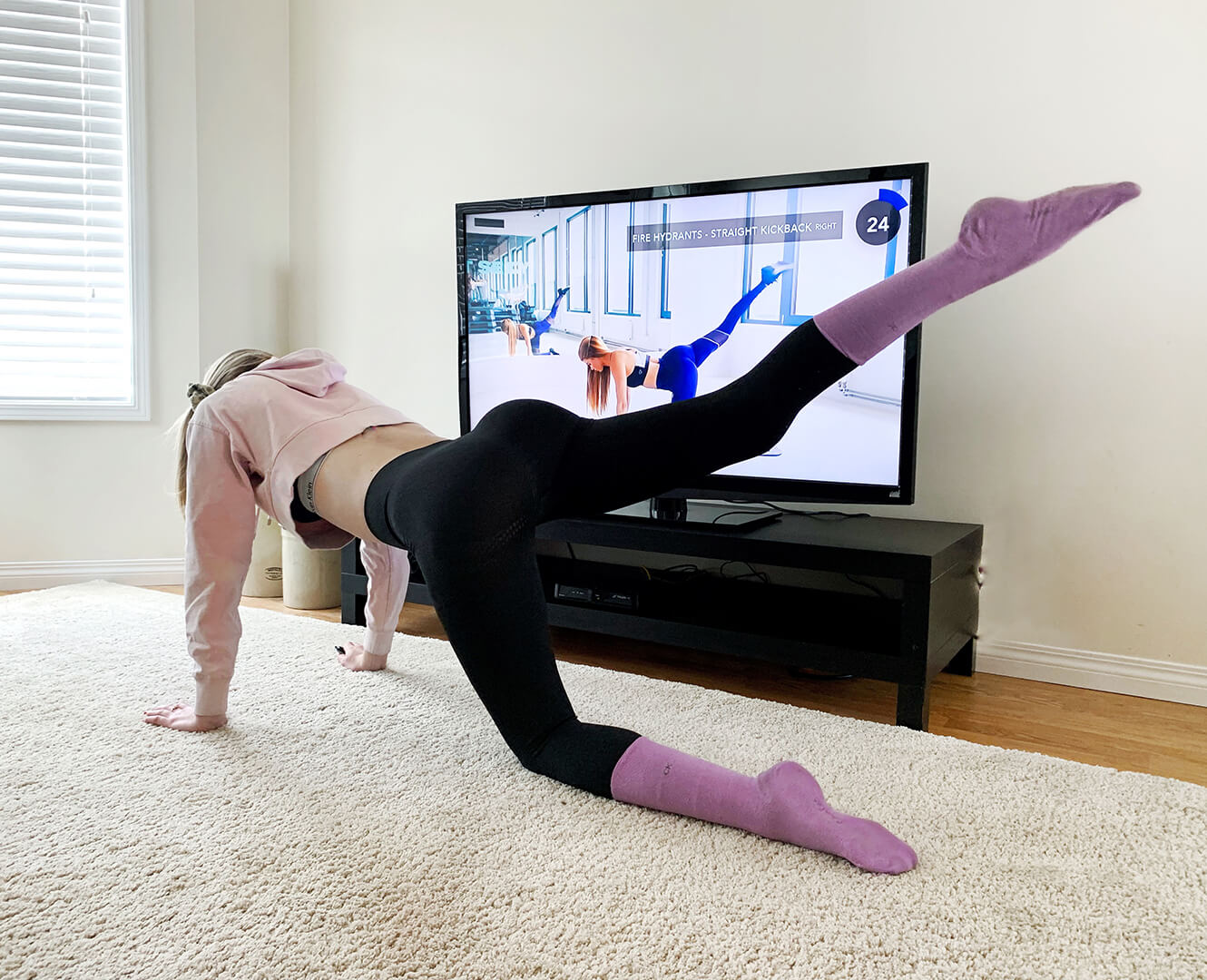 woman working out at home following YouTube video