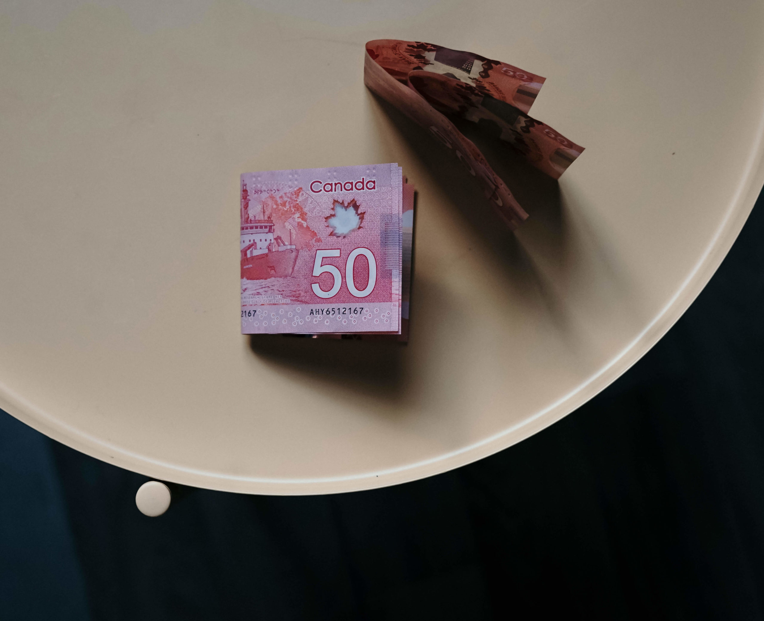 Bill dollar money Canadian fifty dollar bills sit on table