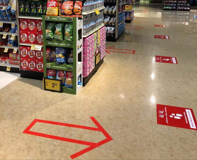 Grocery shopping during COVID 19 arrows on ground