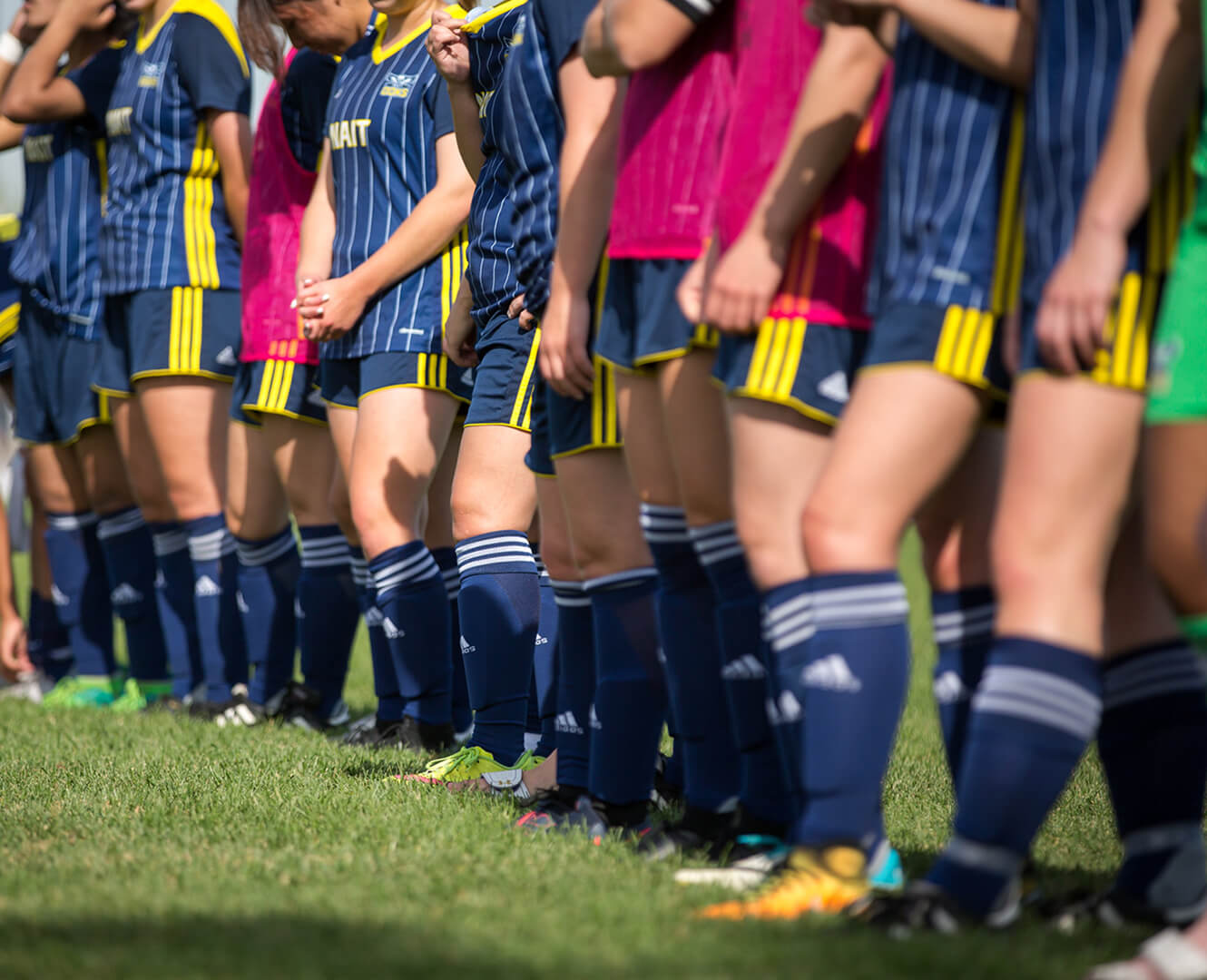 NAIT Ooks women's soccer team stands in a line on the grass