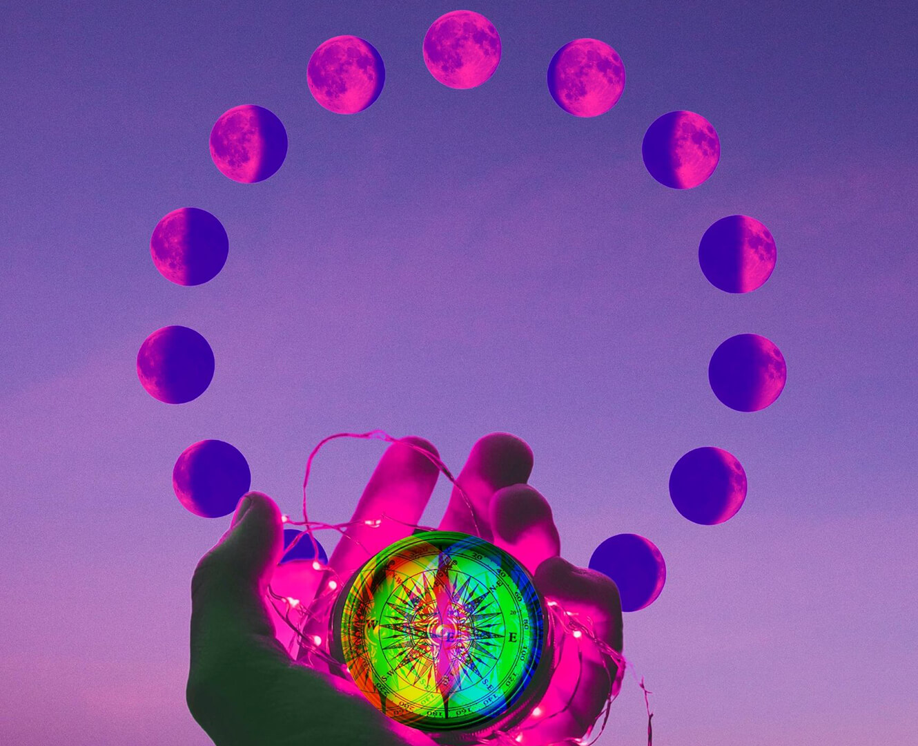 person holding compass in front of 12 moons sphere during dawn