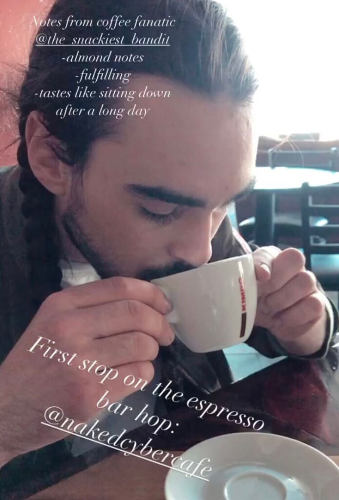 Man sips a cup of espresso in a coffee shop