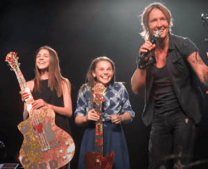 Keith Urban pulls up local singer Hailey Benedict on stage to perform