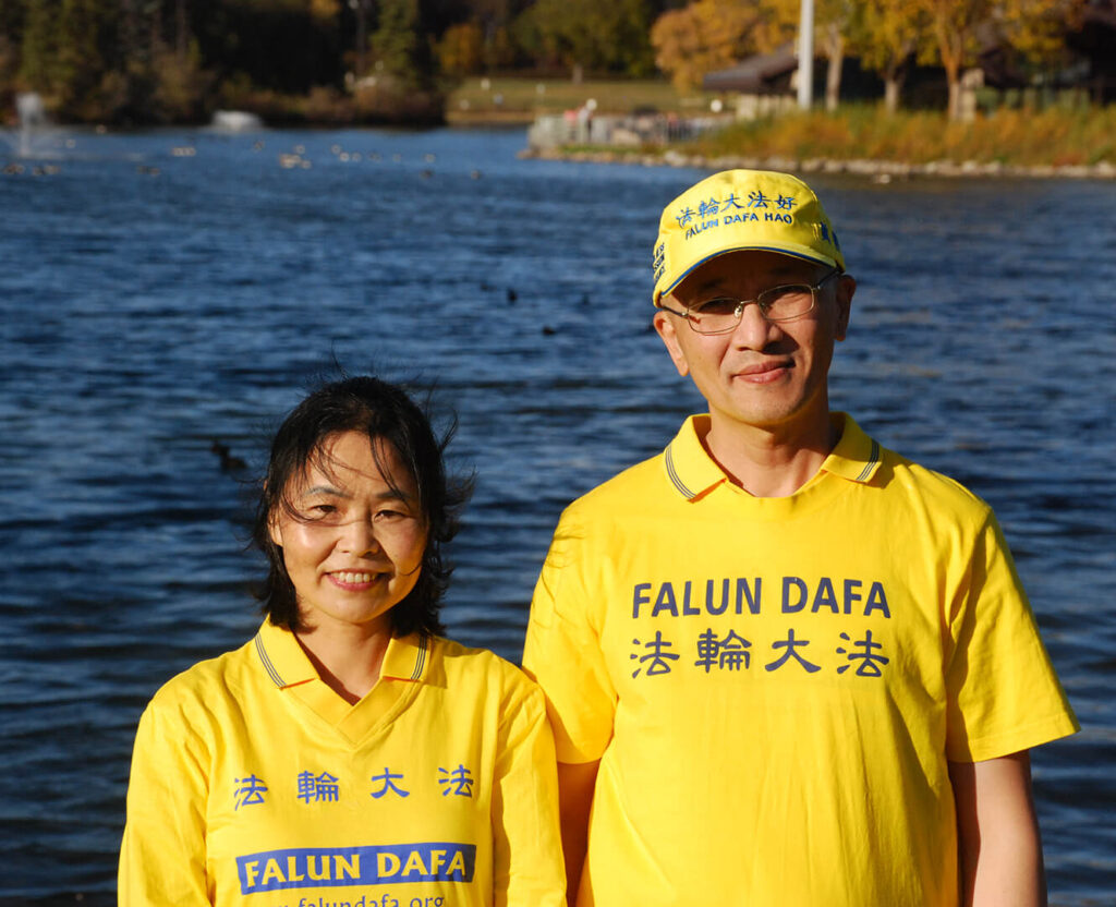 Hong stands with her husband on the river in Edmonton
