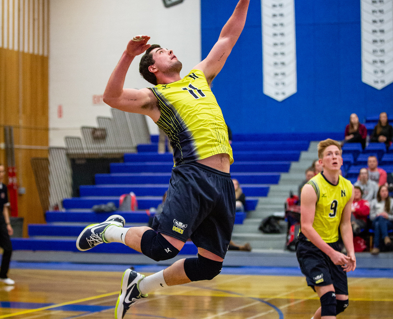 Shapka hits a serve in a Nait ooks volleyball game.