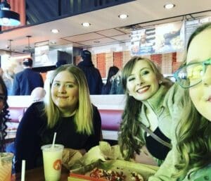 Alexandra, Destiny and their friend at a table