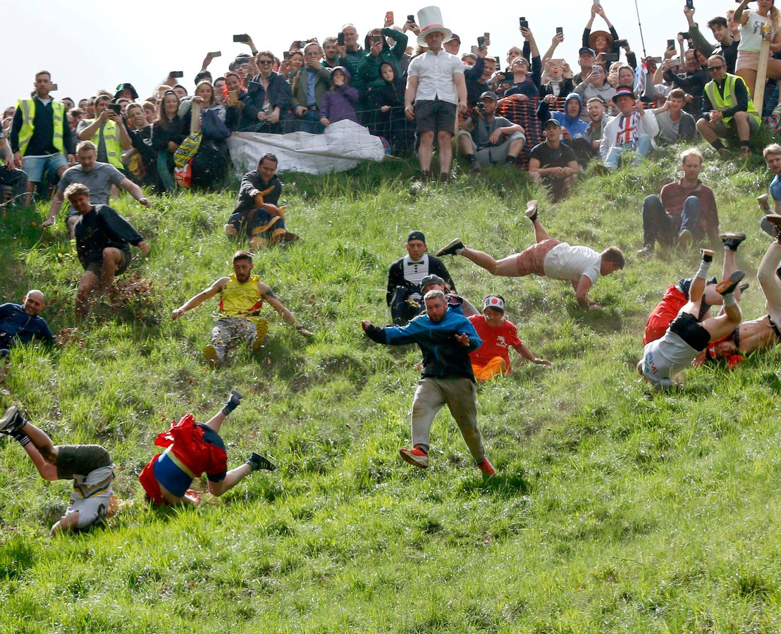 people cheese rolling