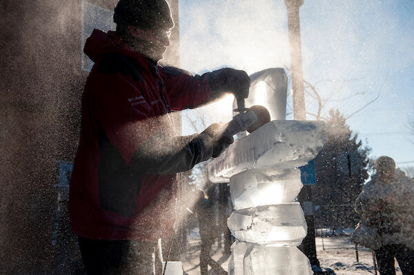man carving ice