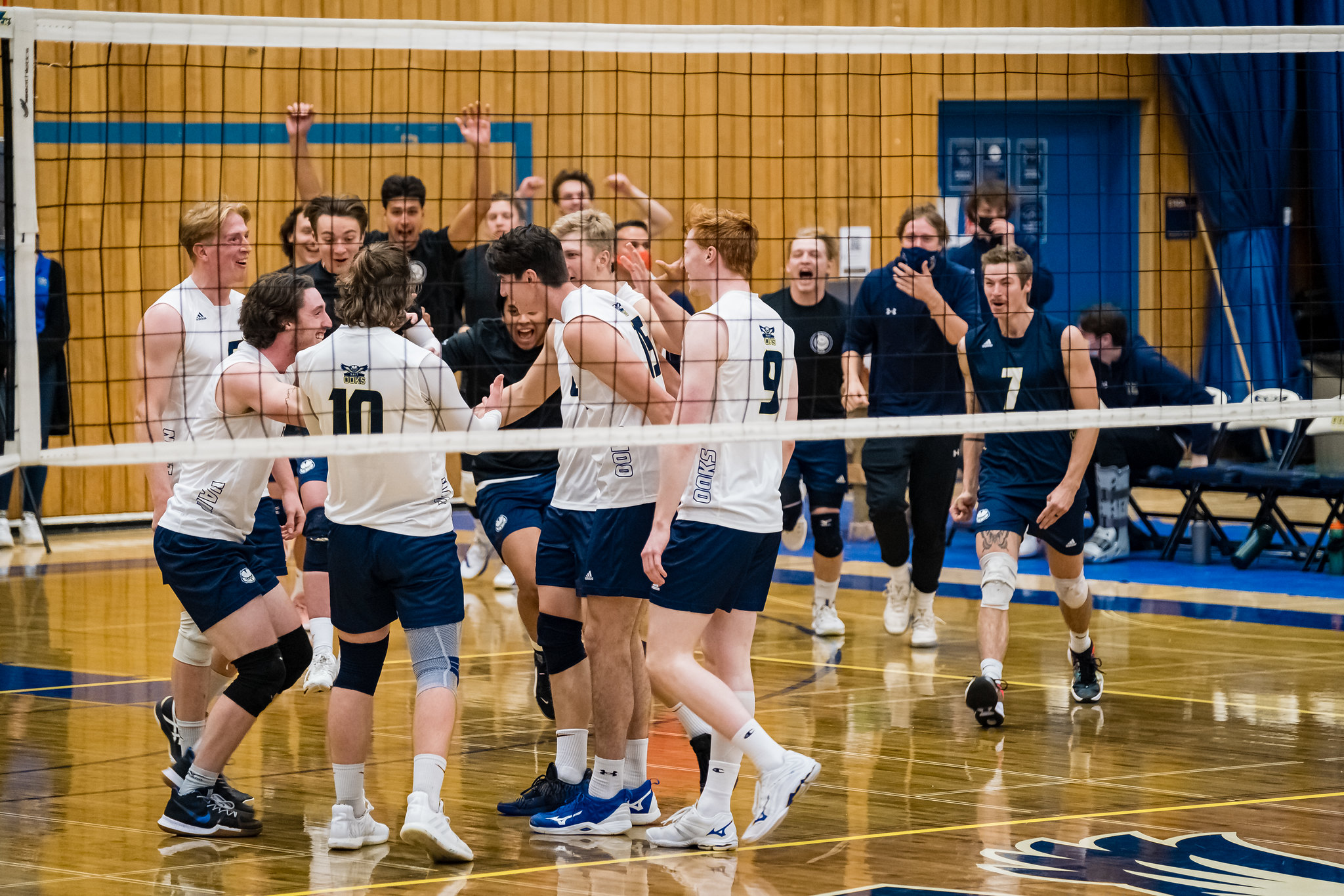 NAIT men's volleyball team celebrates on the court