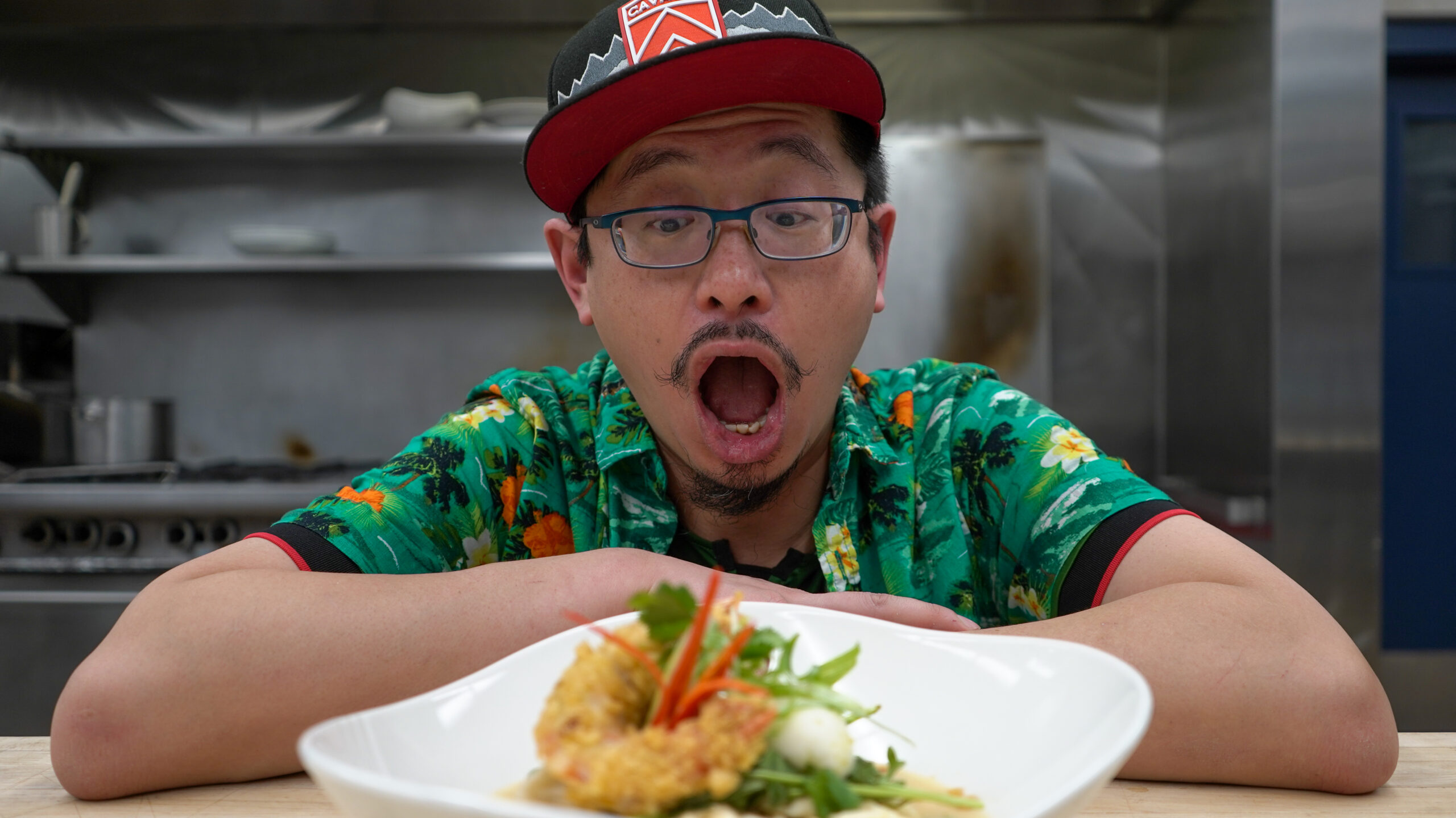 A man with a surprised face stands before his dish.