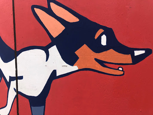 a mural of a dog on a red background