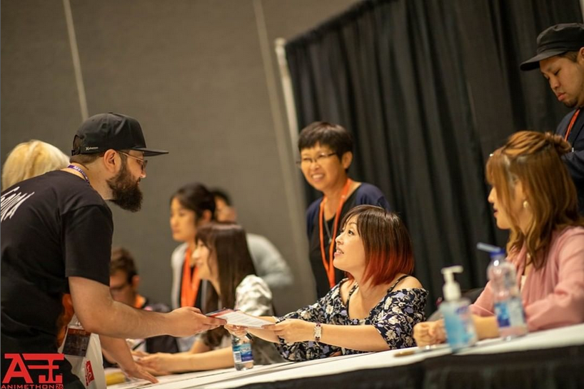 A fan meets someone at Animethon. 