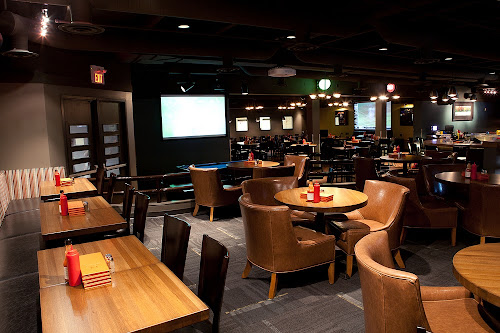 The Nest before renovations. The inside of the Nest showing a darkened colour scheme with tables and chairs.