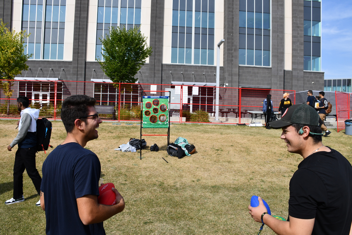 students laugh and play football at nest fest