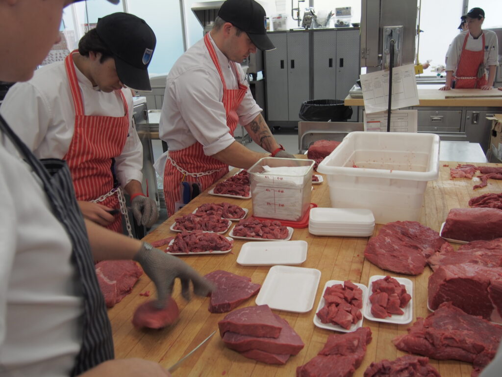 students working in retail meat store 