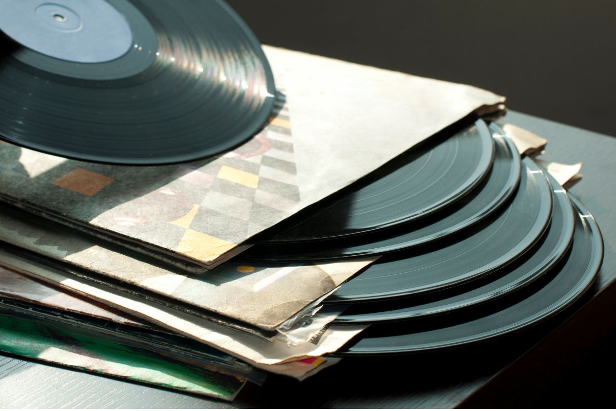 several records in their cardboard packaging are stacked on top of each other